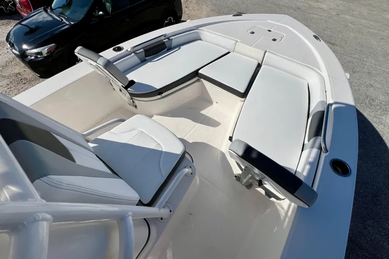 Slide: The Image of 2024 Robalo 206 Cayman boat interior with cushioned seating and steering console. - 19