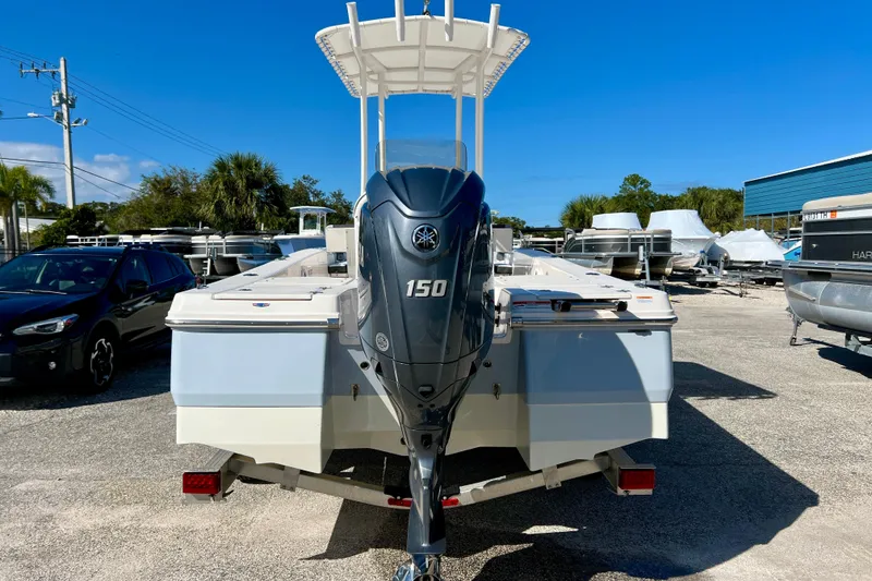 Slide: The Image of 2024 Robalo 206 Cayman boat with Yamaha 150 engine, parked outdoors under clear blue sky. - 7