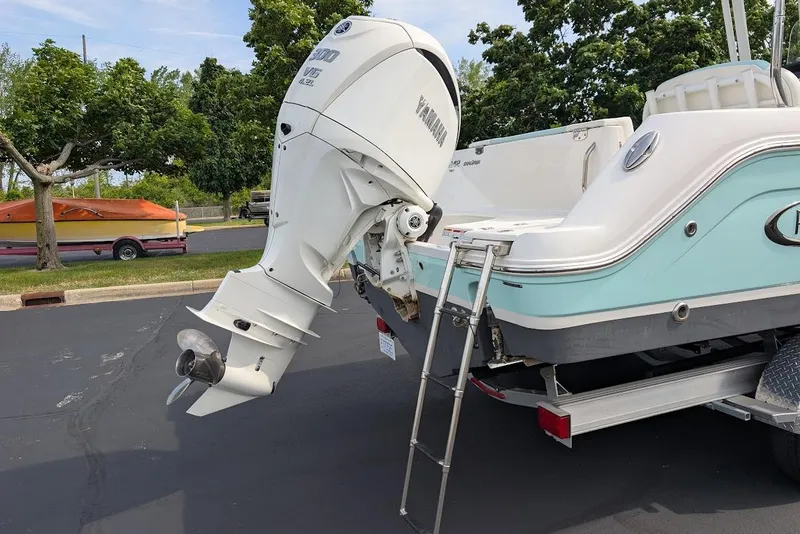 Slide: The Image of 2022 Robalo R242 Explorer boat with Yamaha outboard motor and ladder, parked on trailer. - 10