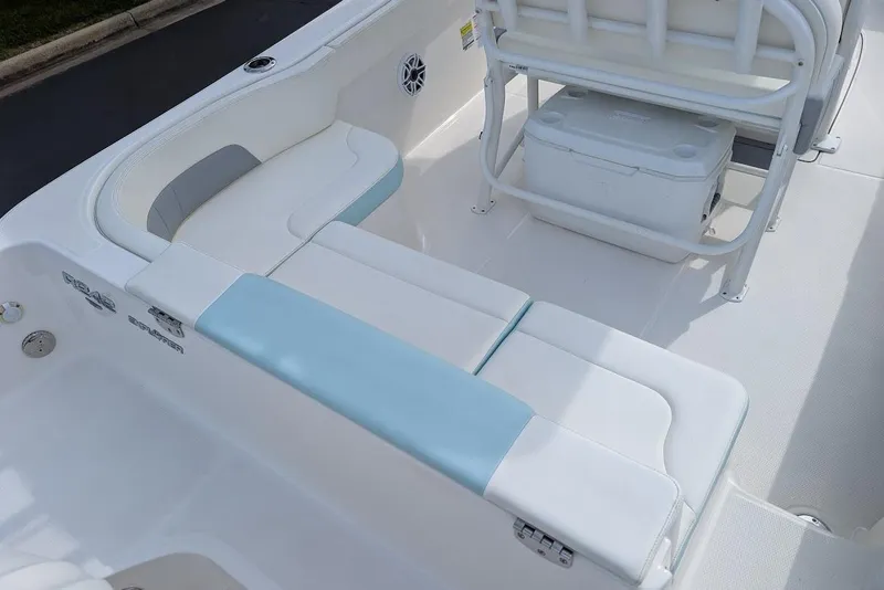 Slide: The Image of 2022 Robalo R242 Explorer boat interior with white and blue seating and storage area. - 14
