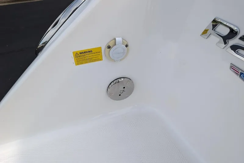 Slide: The Image of 2022 Robalo R242 Explorer boat detail with warning label and fittings. - 15