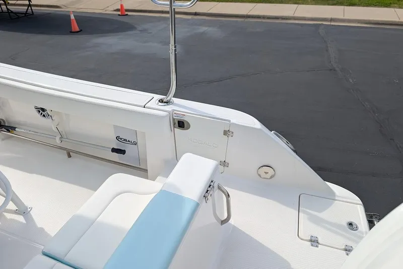 Slide: The Image of 2022 Robalo R242 Explorer boat deck with seating and storage compartments. - 16