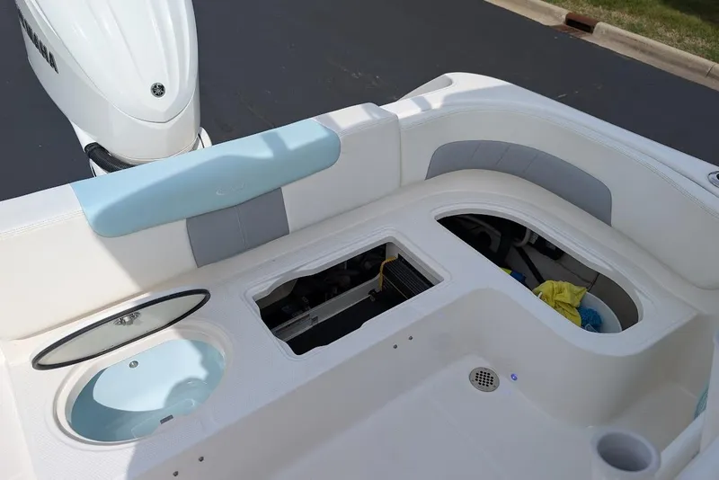 Slide: The Image of 2022 Robalo R242 Explorer boat interior with storage compartments and Yamaha engine. - 18