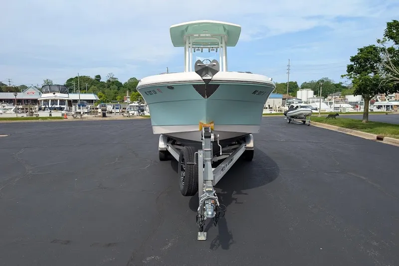 Slide: The Image of 2022 Robalo R242 Explorer boat on trailer in marina parking lot. - 2