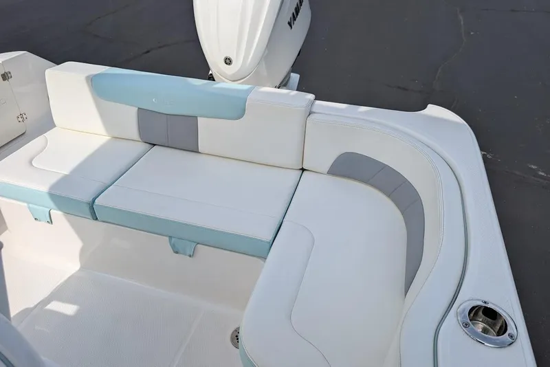 Slide: The Image of 2022 Robalo R242 Explorer boat seating area with white and blue cushions. - 20