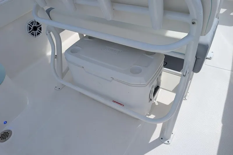 Slide: The Image of 2022 Robalo R242 Explorer boat interior with cooler storage under seat. - 22