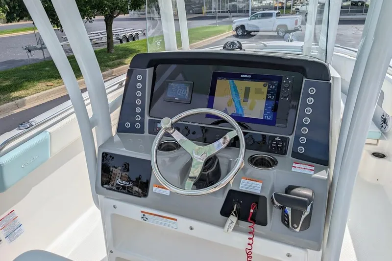 Slide: The Image of 2022 Robalo R242 Explorer boat dashboard with steering wheel and navigation display. - 23