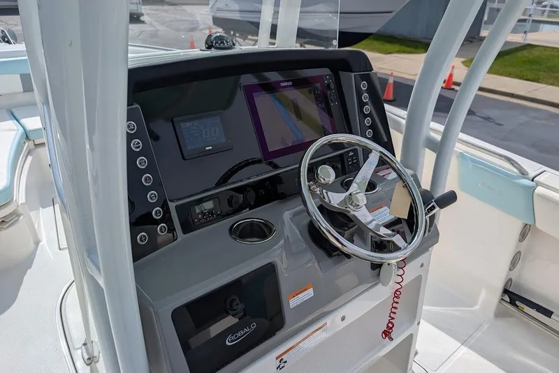 Slide: The Image of 2022 Robalo R242 Explorer boat dashboard with steering wheel and navigation system. - 24