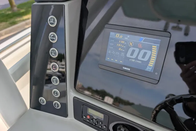 Slide: The Image of Dashboard of 2022 Robalo R242 Explorer boat with Yamaha display and control buttons. - 25
