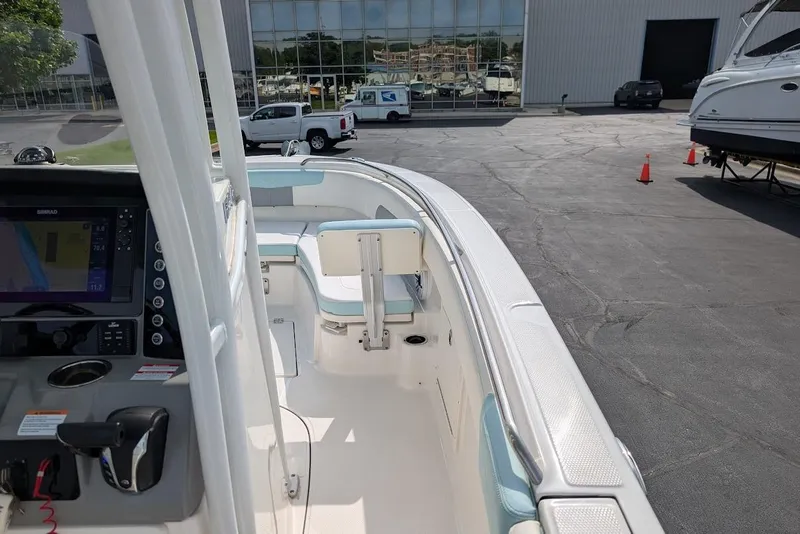 Slide: The Image of 2022 Robalo R242 Explorer boat interior with navigation system and seating. - 27