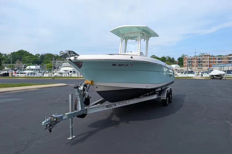 Slide: The Image of 2022 Robalo R242 Explorer boat on trailer in marina parking lot. - 3