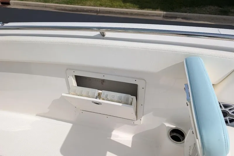 Slide: The Image of 2022 Robalo R242 Explorer boat interior with storage compartment and seating. - 32