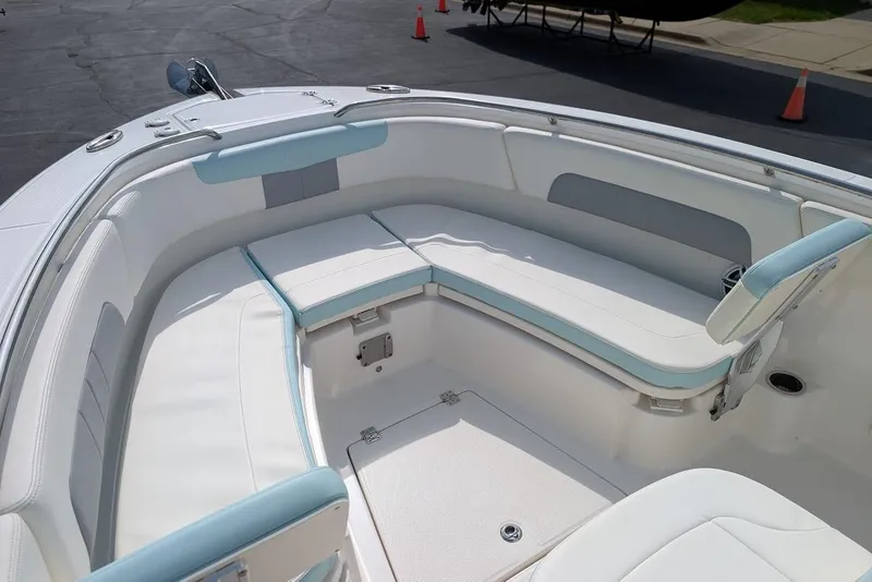 Slide: The Image of 2022 Robalo R242 Explorer boat interior with white and blue seating. - 33