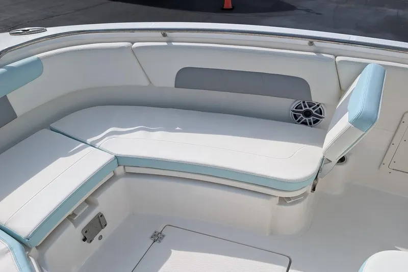 Slide: The Image of 2022 Robalo R242 Explorer boat interior with cushioned seating and speaker. - 34