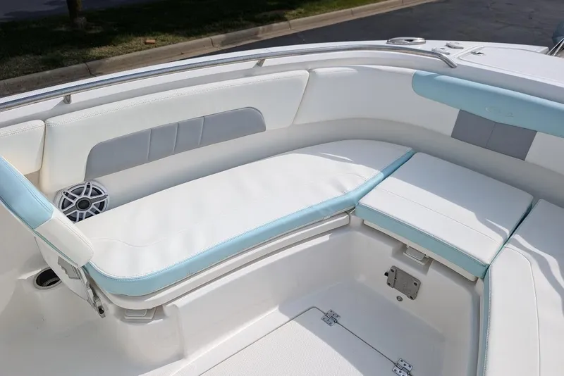 Slide: The Image of 2022 Robalo R242 Explorer boat interior with white and blue cushioned seating. - 35