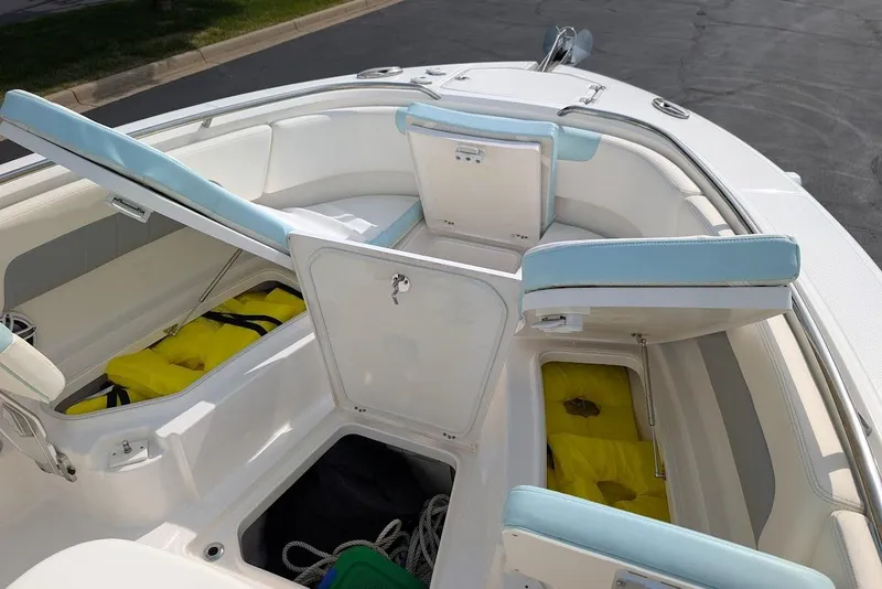 Slide: The Image of 2022 Robalo R242 Explorer boat interior with open storage compartments and seating. - 36