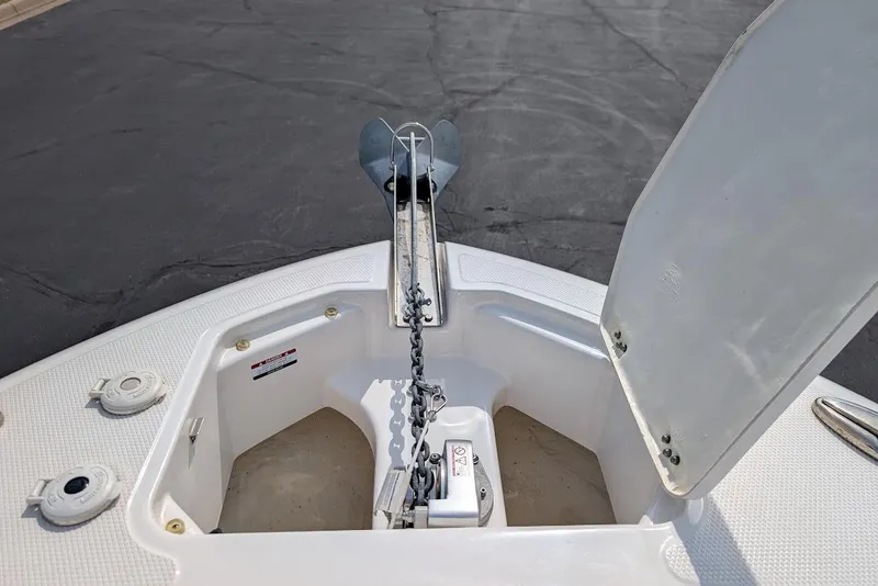 Slide: The Image of 2022 Robalo R242 Explorer boat anchor compartment with chain and open hatch. - 37