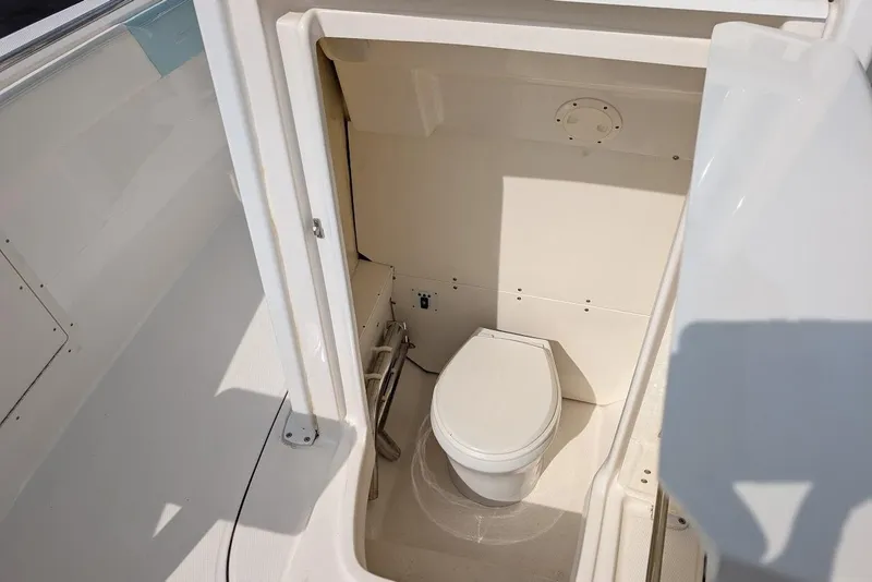Slide: The Image of 2022 Robalo R242 Explorer boat interior with compact marine toilet. - 39