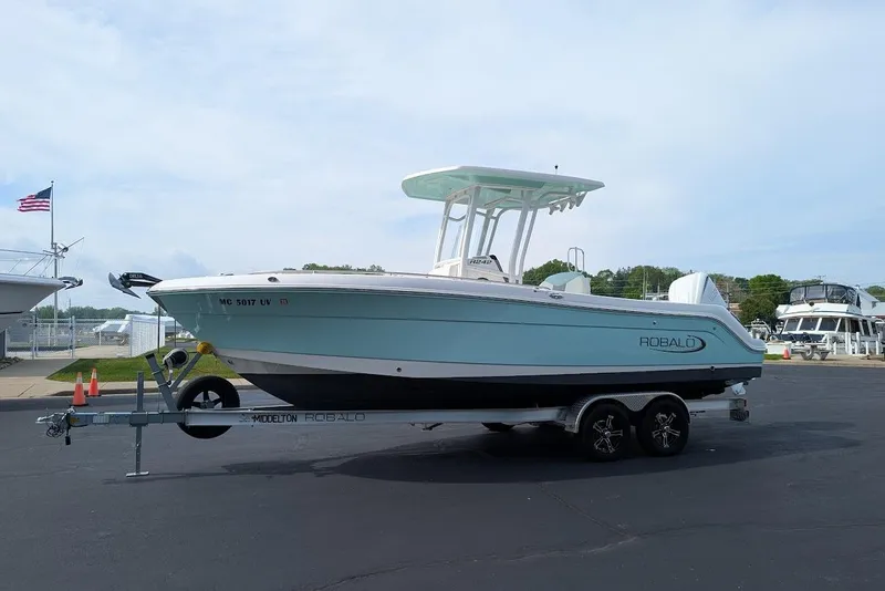 Slide: The Image of 2022 Robalo R242 Explorer boat on trailer in marina parking lot. - 4