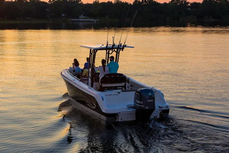Slide: The Image of 2022 Robalo R242 Explorer boat on water at sunset. - 44