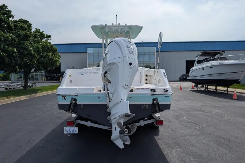 Slide: The Image of 2022 Robalo R242 Explorer boat with powerful outboard engine, parked near a marina. - 7
