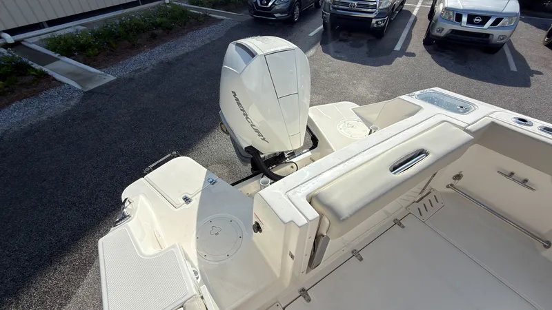 Slide: The Image of The image shows the stern of a Boston Whaler 240 Vantage boat with a Mercury outboard motor. - 35