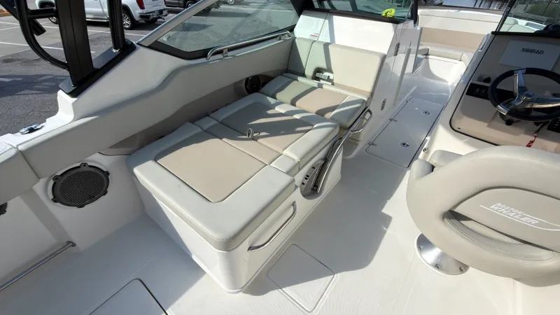 Slide: The Image of Interior of a Boston Whaler 240 Vantage with beige cushioned seating and helm console. - 28