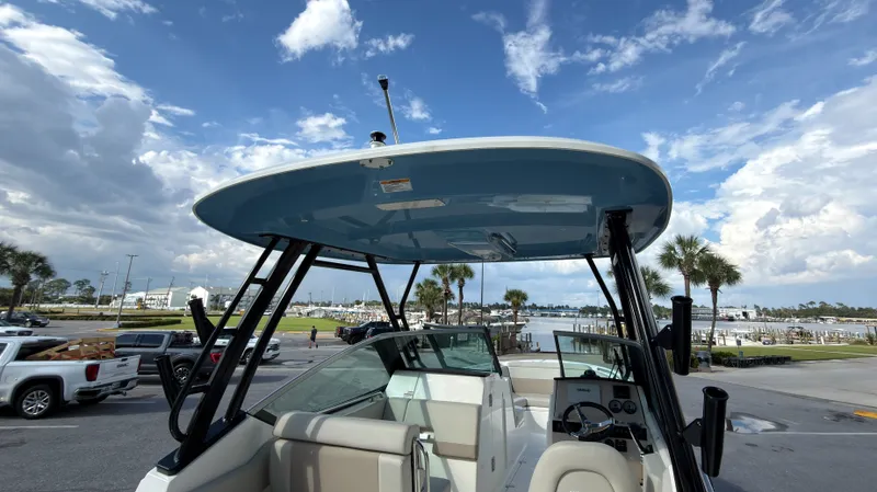 Slide: The Image of Boston Whaler 240 Vantage 2027 with blue hardtop and modern helm console at the marina. - 34