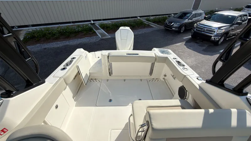 Slide: The Image of The image shows the cockpit of a 2027 Boston Whaler 240 Vantage with beige seating and storage. - 29