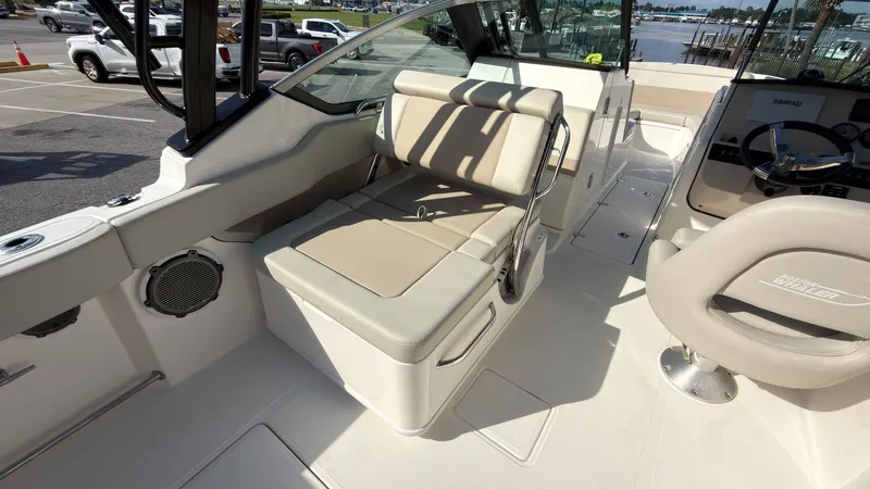 Slide: The Image of The image shows the cockpit of a 2027 Boston Whaler 240 Vantage with beige seating. - 26