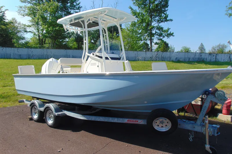 The Image of 2026 Boston Whaler 210 Montauk boat on trailer, parked outdoors on a sunny day. - 1