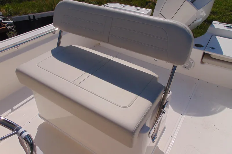 Slide: The Image of 2026 Boston Whaler 210 Montauk boat seat, featuring sleek white upholstery. - 10