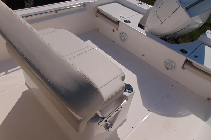 Slide: The Image of Interior view of 2026 Boston Whaler 210 Montauk boat, featuring seating and engine area. - 11