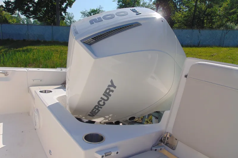 Slide: The Image of 2026 Boston Whaler 210 Montauk with Mercury outboard engine in a grassy setting. - 4
