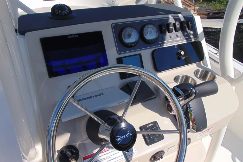 Slide: The Image of Steering console of 2026 Boston Whaler 210 Montauk with Simrad electronics and gauges. - 8