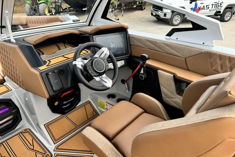 Slide: The Image of 2026 Tigé 24RZX boat interior with modern dashboard, touchscreen, and luxurious seating. - 11