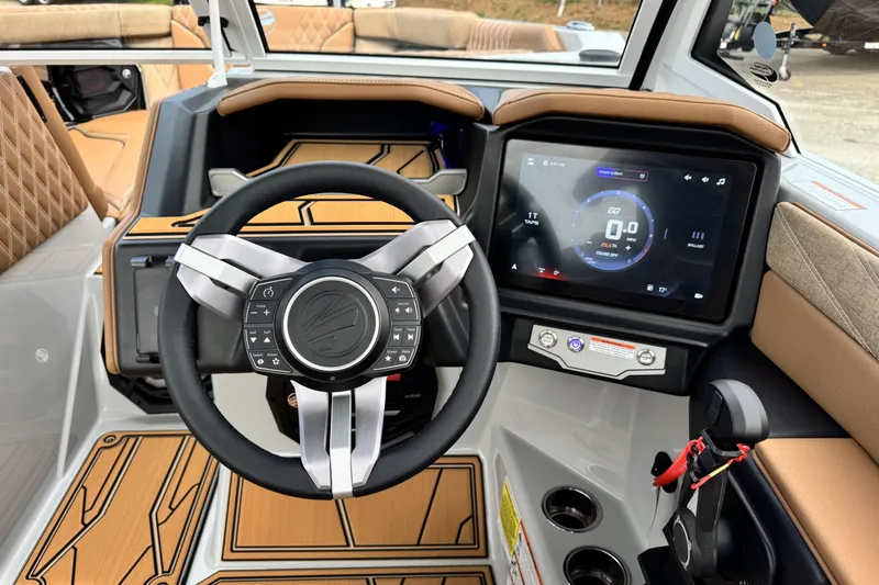 Slide: The Image of Interior of 2026 Tigé 24RZX boat featuring modern steering wheel and touchscreen display. - 12