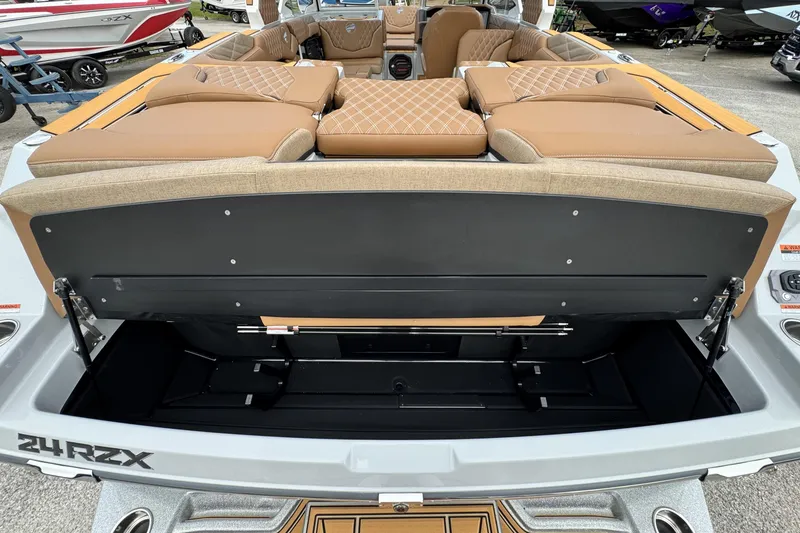 Slide: The Image of 2026 Tigé 24RZX boat with open rear storage compartment and luxurious seating. - 18