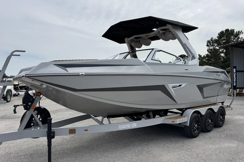 Slide: The Image of 2026 Tigé 24RZX boat on trailer, sleek design, parked outdoors. - 8