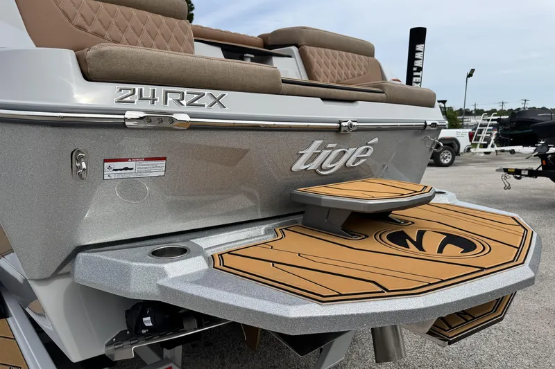 Slide: The Image of 2026 Tigé 24RZX boat rear view with swim platform and seating. - 9