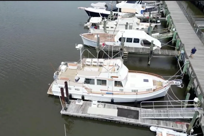 The Image of 1989 Grand Banks 42 Motoryacht docked at marina, aerial view. - 0