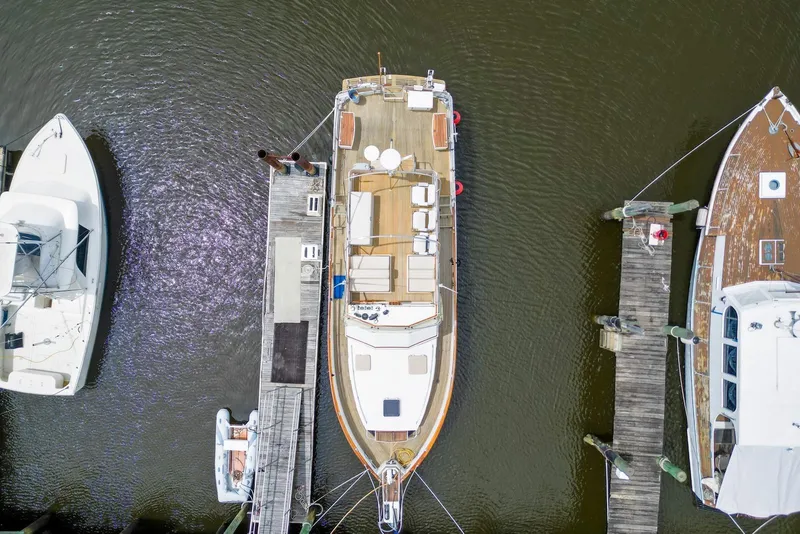 Slide: The Image of Aerial view of 1989 Grand Banks 42 Motoryacht docked between two boats. - 2