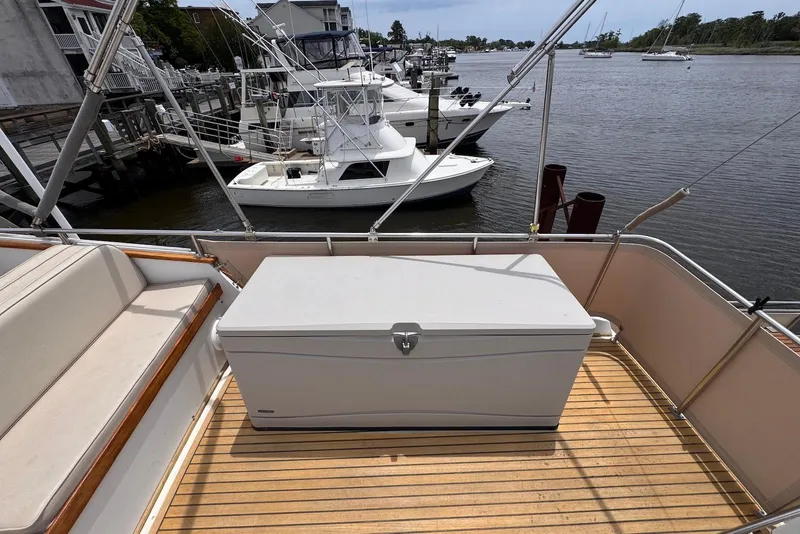 Slide: The Image of 1989 Grand Banks 42 Motoryacht deck with storage box, overlooking marina and boats. - 25
