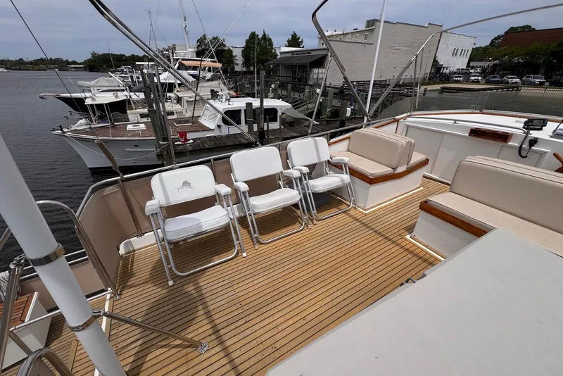 Slide: The Image of 1989 Grand Banks 42 Motoryacht deck with seating, docked at marina. - 26