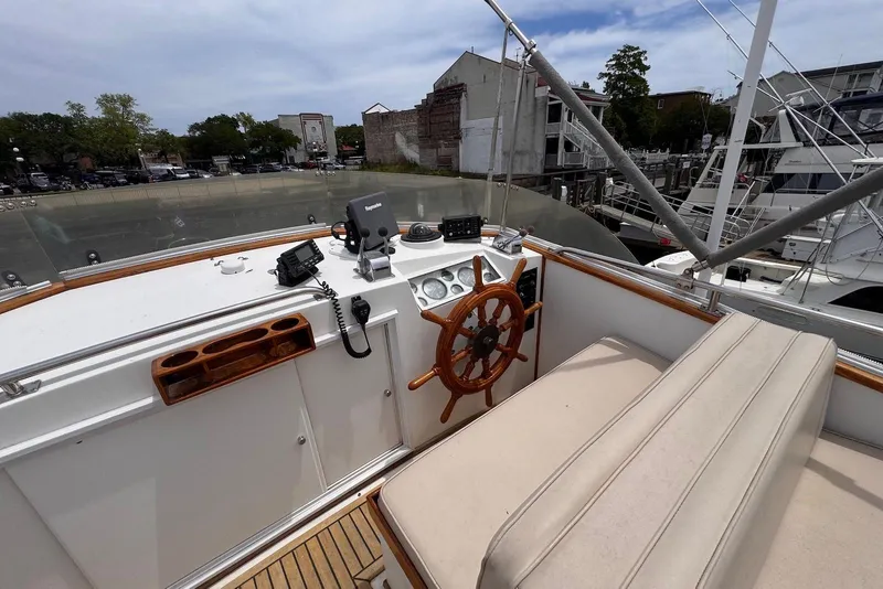 Slide: The Image of 1989 Grand Banks 42 Motoryacht helm with wooden wheel and navigation equipment. - 30