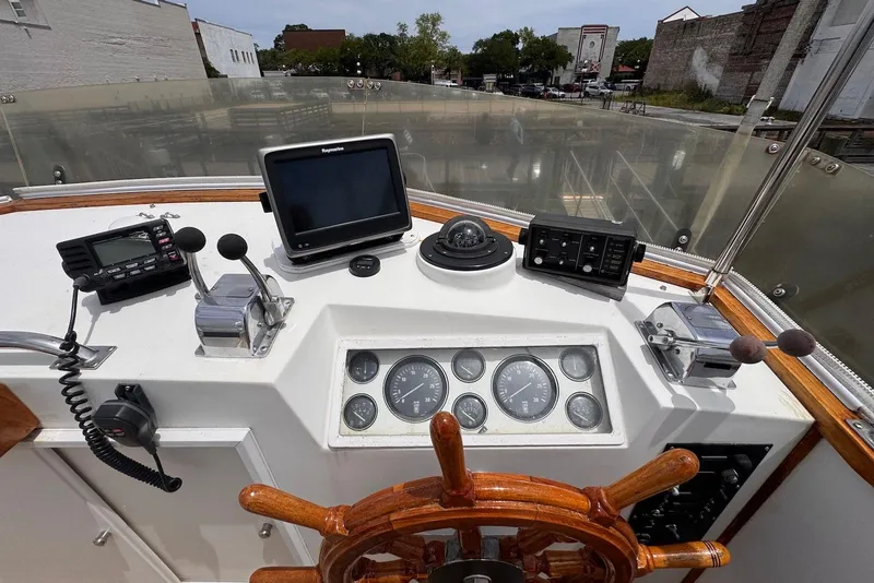Slide: The Image of Helm of 1989 Grand Banks 42 Motoryacht with navigation instruments and wooden steering wheel. - 31