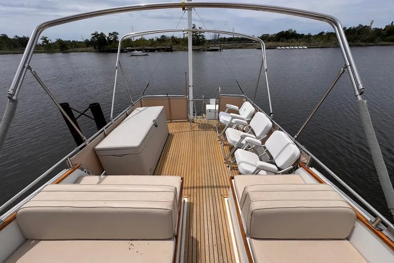 Slide: The Image of 1989 Grand Banks 42 Motoryacht deck with seating, overlooking calm waters. - 32
