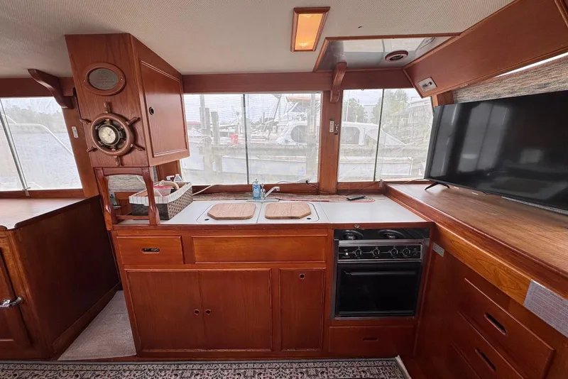 Slide: The Image of Interior of 1989 Grand Banks 42 Motoryacht with wooden cabinetry and kitchen amenities. - 34