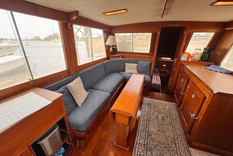 Slide: The Image of Interior of 1989 Grand Banks 42 Motoryacht with wooden furnishings and blue sofa. - 36