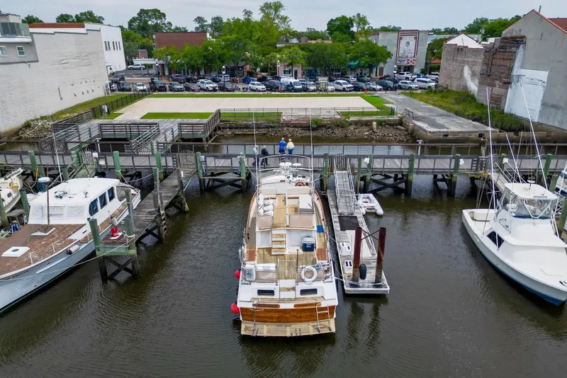 Slide: The Image of Aerial view of 1989 Grand Banks 42 Motoryacht docked at a marina with nearby boats. - 4